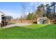 Large backyard featuring a shed, picnic table under a pergola, swimming pool and privacy fence at 322 Equinox Cir, Ladson, SC 29456