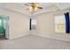 Spacious bedroom with a tray ceiling, ceiling fan, and neutral carpet at 322 Equinox Cir, Ladson, SC 29456