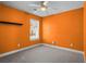 Vibrant bedroom with orange walls, a ceiling fan, and a window at 322 Equinox Cir, Ladson, SC 29456