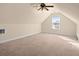 Spacious bonus room featuring a large window, vaulted ceilings, and neutral carpet at 322 Equinox Cir, Ladson, SC 29456