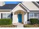 Close up of a charming front door with a bright blue finish, white trim and well maintained landscaping at 322 Equinox Cir, Ladson, SC 29456