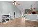Open living room with vaulted ceiling, fan, fireplace, view of kitchen, and access to backyard at 322 Equinox Cir, Ladson, SC 29456