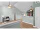 Open living room with high ceilings, ceiling fan, fireplace, and view into the kitchen at 322 Equinox Cir, Ladson, SC 29456