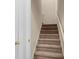 Carpeted staircase featuring a neutral color, and white trim at 322 Equinox Cir, Ladson, SC 29456
