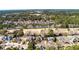 Aerial view of a brick home in a neighborhood surrounded by lush greenery at 3334 Merion Pl, Mount Pleasant, SC 29466
