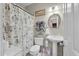 Elegant bathroom featuring a pedestal sink, decorative mirror, and a stylish shower curtain with black and white accents at 3334 Merion Pl, Mount Pleasant, SC 29466