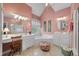 Well-lit bathroom with dual vanities, tub, and a separate glass enclosed shower at 3334 Merion Pl, Mount Pleasant, SC 29466