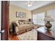 Cozy bedroom showcasing hardwood floors, a comfortable daybed with decorative pillows, and a window with natural light at 3334 Merion Pl, Mount Pleasant, SC 29466