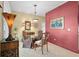Dining room features a glass top table, decorative chairs, and warm lighting at 3334 Merion Pl, Mount Pleasant, SC 29466