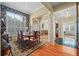 Formal dining room features hardwood floors, plantation shutters, designer wallpaper, and stylish furnishings at 3334 Merion Pl, Mount Pleasant, SC 29466