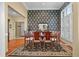 Charming dining room featuring elegant wallpaper, wood table and chairs, and a decorative mirror at 3334 Merion Pl, Mount Pleasant, SC 29466