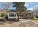 Brick home featuring an enclosed porch and a small wooden deck at 3334 Merion Pl, Mount Pleasant, SC 29466