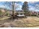 Rear view of brick home featuring a sunroom and well-maintained backyard at 3334 Merion Pl, Mount Pleasant, SC 29466