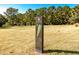 Golf course hole marker under a sunny sky, showcasing the manicured green and fairway at 3334 Merion Pl, Mount Pleasant, SC 29466