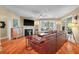 Living room featuring a fireplace, hardwood floors, and a large window at 3334 Merion Pl, Mount Pleasant, SC 29466