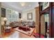 Comfortable living room with hardwood floors, plush sofas, a decorative rug, and ample natural light at 3334 Merion Pl, Mount Pleasant, SC 29466