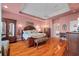 Elegant main bedroom featuring hardwood floors, a ceiling fan, and warm, inviting colors at 3334 Merion Pl, Mount Pleasant, SC 29466