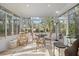 Cozy sunroom dining area with wrought iron furniture, large windows, and views of the outdoors at 3334 Merion Pl, Mount Pleasant, SC 29466