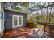 A wooden deck with railing features double doors leading to the home's backyard at 3920 Hanoverian Dr, Mount Pleasant, SC 29429