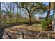 Backyard with mature trees, lush lawn, and a wooden privacy fence at 3920 Hanoverian Dr, Mount Pleasant, SC 29429