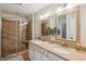 Bathroom featuring double sinks, granite countertops, and a tiled shower with glass door at 3920 Hanoverian Dr, Mount Pleasant, SC 29429