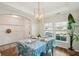 Dining area with a statement light fixture, wainscoting, and a view of the front yard at 3920 Hanoverian Dr, Mount Pleasant, SC 29429