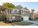 Two-story home featuring stone accents, an attached two-car garage, and a manicured front yard at 3920 Hanoverian Dr, Mount Pleasant, SC 29429