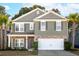 Two-story home featuring stone accents, an attached two-car garage, and a manicured front yard at 3920 Hanoverian Dr, Mount Pleasant, SC 29429