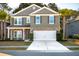 Charming two-story home featuring a two-car garage, stone accents and manicured landscaping at 3920 Hanoverian Dr, Mount Pleasant, SC 29429