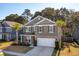 Inviting two-story home with a two car garage, stone accents, manicured lawn, and mature trees at 3920 Hanoverian Dr, Mount Pleasant, SC 29429