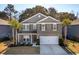 Inviting two-story home with a two car garage, stone accents, manicured lawn, and mature trees at 3920 Hanoverian Dr, Mount Pleasant, SC 29429