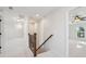 Hallway with neutral carpet, wood railing staircase, and views into adjacent rooms at 3920 Hanoverian Dr, Mount Pleasant, SC 29429