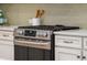 This is a close up of the stainless steel range/oven in the lovely kitchen at 3920 Hanoverian Dr, Mount Pleasant, SC 29429