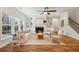 Bright living room features a fireplace, built-in shelving, wood floors, and a ceiling fan at 3920 Hanoverian Dr, Mount Pleasant, SC 29429
