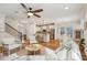 Open-concept living area with hardwood floors, ceiling fan, and a view of the modern kitchen at 3920 Hanoverian Dr, Mount Pleasant, SC 29429