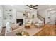 Bright living room features a fireplace, built-in shelving, wood floors, and a ceiling fan at 3920 Hanoverian Dr, Mount Pleasant, SC 29429