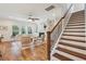 Bright living room with fireplace, ceiling fan, wood floors, and staircase to the second floor at 3920 Hanoverian Dr, Mount Pleasant, SC 29429