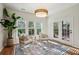 Cozy sun room featuring a decorative rug, two chairs, three large windows and french doors at 3920 Hanoverian Dr, Mount Pleasant, SC 29429