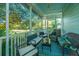 Relaxing screened porch featuring comfortable seating and a view of the surrounding trees at 5302 E Dolphin St, North Charleston, SC 29405