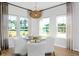 Cozy dining area with a view of the backyard, pendant lighting, and hardwood flooring at 564 Richfield Way, Summerville, SC 29486