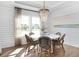 Bright dining area featuring shiplap walls, modern light fixture, and large windows for an abundance of natural light at 564 Richfield Way, Summerville, SC 29486