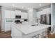 Bright kitchen with stainless steel appliances, white cabinets, quartz countertops, and bar stool seating at the island at 564 Richfield Way, Summerville, SC 29486