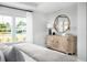 Bright and airy main bedroom features large windows and a decorative cabinet with mirror at 564 Richfield Way, Summerville, SC 29486
