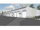 Exterior view of storage units, showing multiple bays, with white walls, and ample parking at 565 Faison Rd # 57, Mount Pleasant, SC 29466