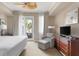 Bright bedroom with a king-size bed, seating area, and balcony access at 5800 Palmetto Dr # Vg-105, Isle of Palms, SC 29451