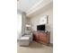Comfortable bedroom featuring a sitting chair with ottoman, dresser with television, and soft lighting at 5800 Palmetto Dr # Vg-105, Isle of Palms, SC 29451