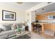 Cozy open-concept living area with kitchen bar seating, sofa, and art at 5800 Palmetto Dr # Vg-105, Isle of Palms, SC 29451