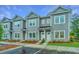 Gray two-story townhomes featuring manicured front lawns, symmetrical facades, and white doors and window trim at 704 Twin Rivers Dr # 44, Wando, SC 29492