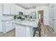 Kitchen featuring granite countertops, stainless steel appliances, white cabinetry, and a breakfast bar at 704 Twin Rivers Dr # 44, Wando, SC 29492