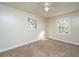 Cozy bedroom features neutral walls, carpet, ceiling fan, and bright windows at 7639 Northhaven Dr, North Charleston, SC 29420